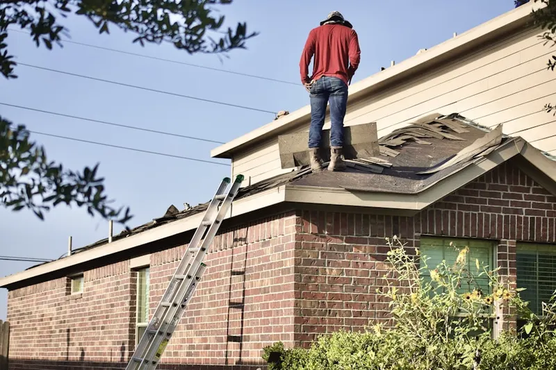 Professional roofer working on a residential roof in Ricard
